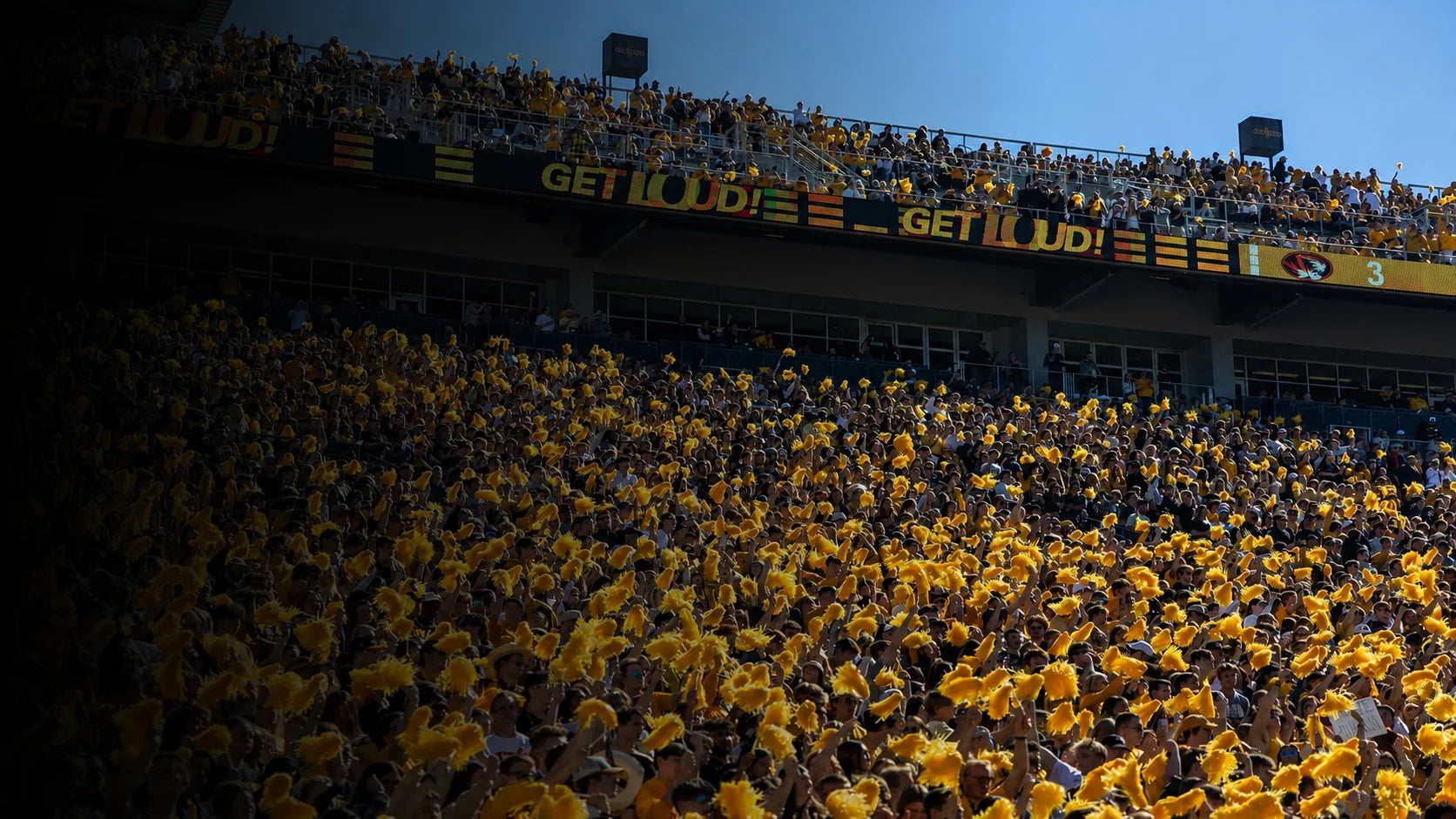 Mizzou football crowd waving gold pom-poms